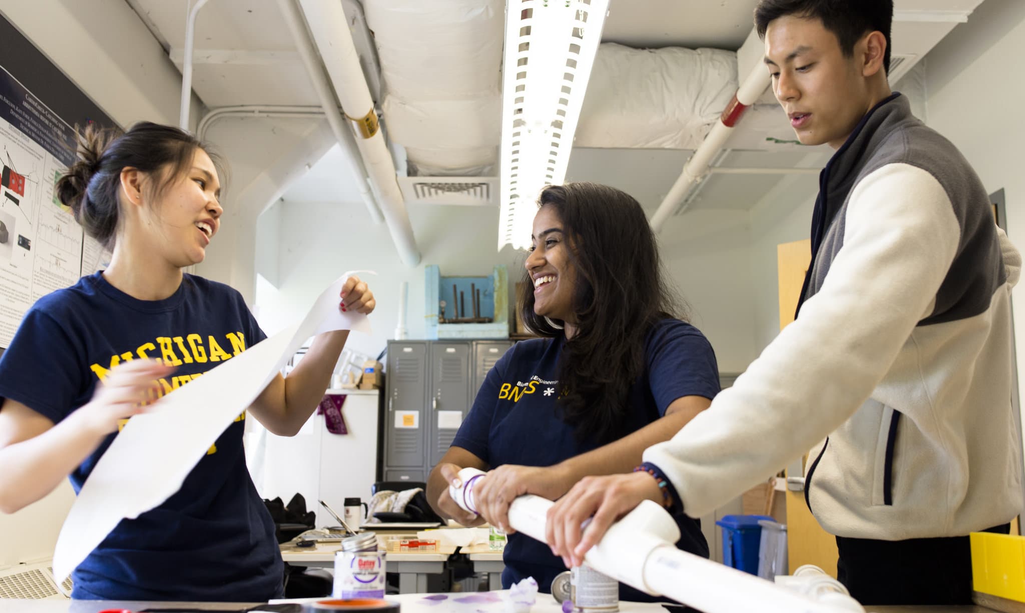 Three students working together in a classroom