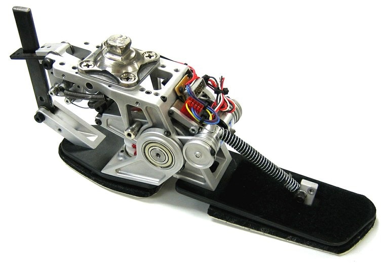 A mechanical device with metal and wires that resembles the shape of a foot