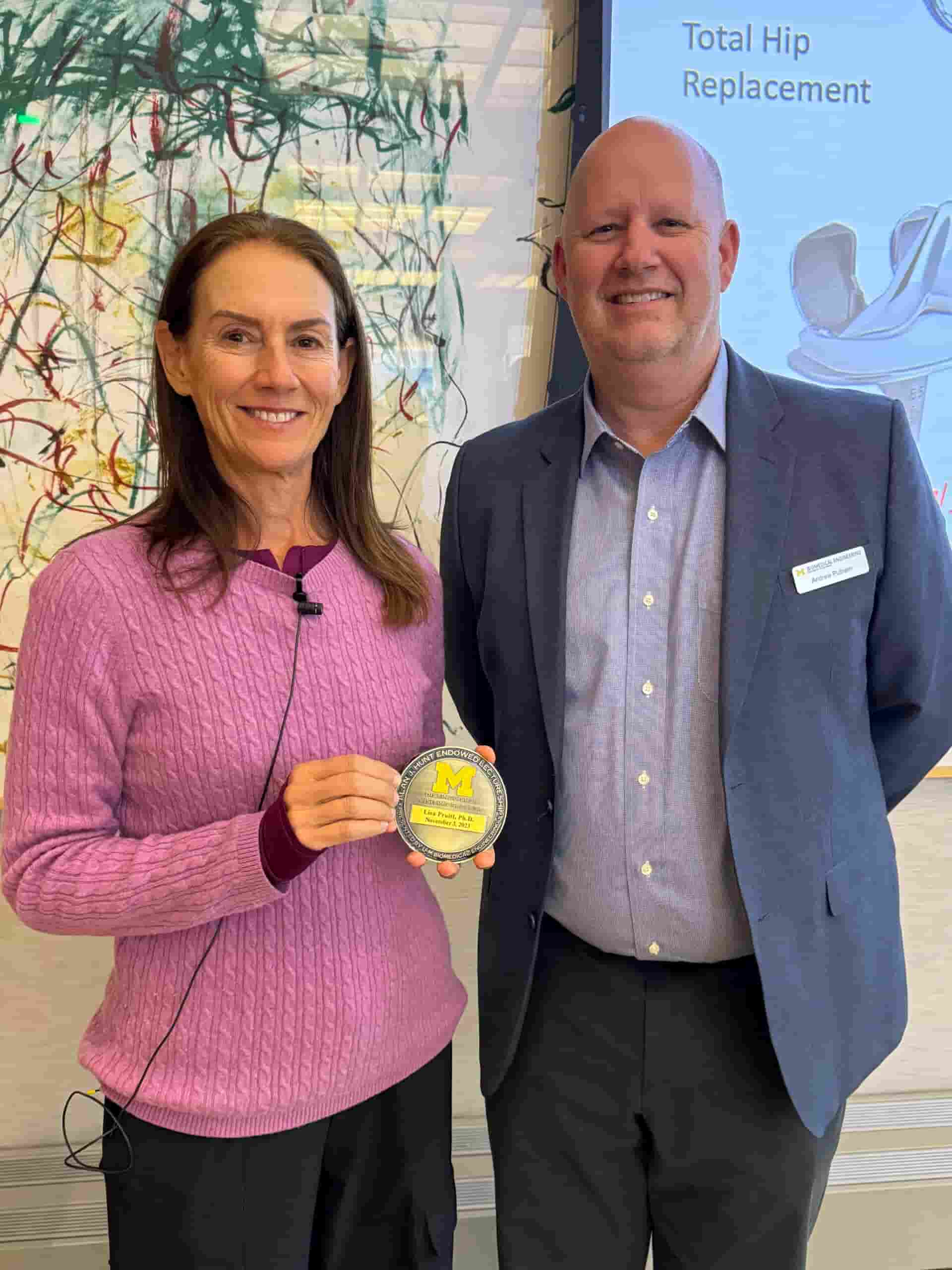 Lisa Pruitt holding a medallion with Andrew Putnam