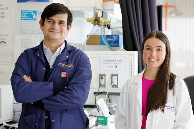 Carlos Aguilar with a student in a lab