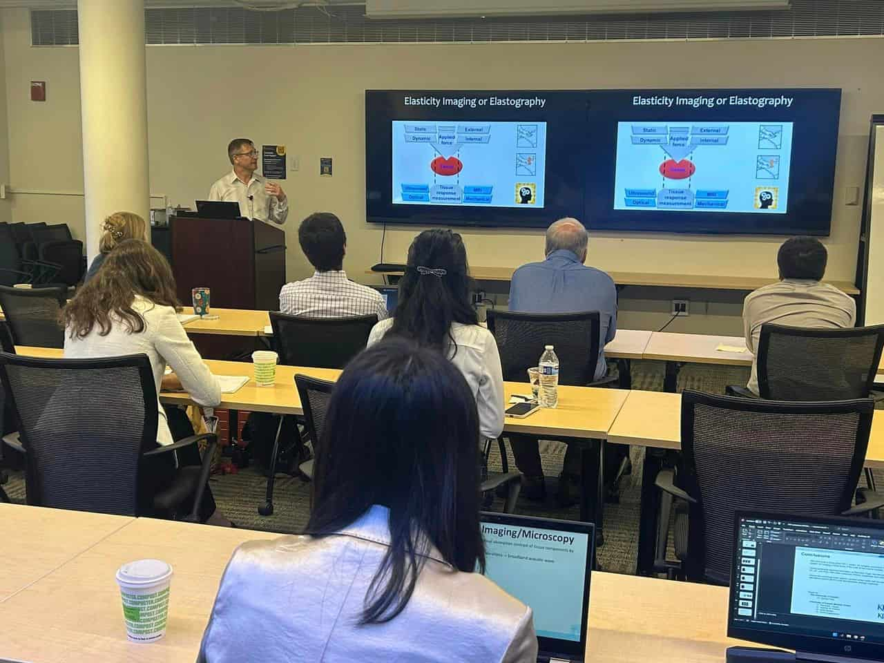 speaker presenting to faculty in a room