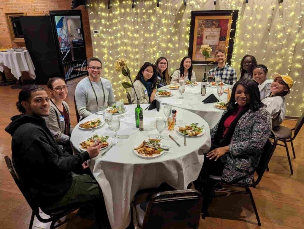 Group of students, staff and faculty having dinner